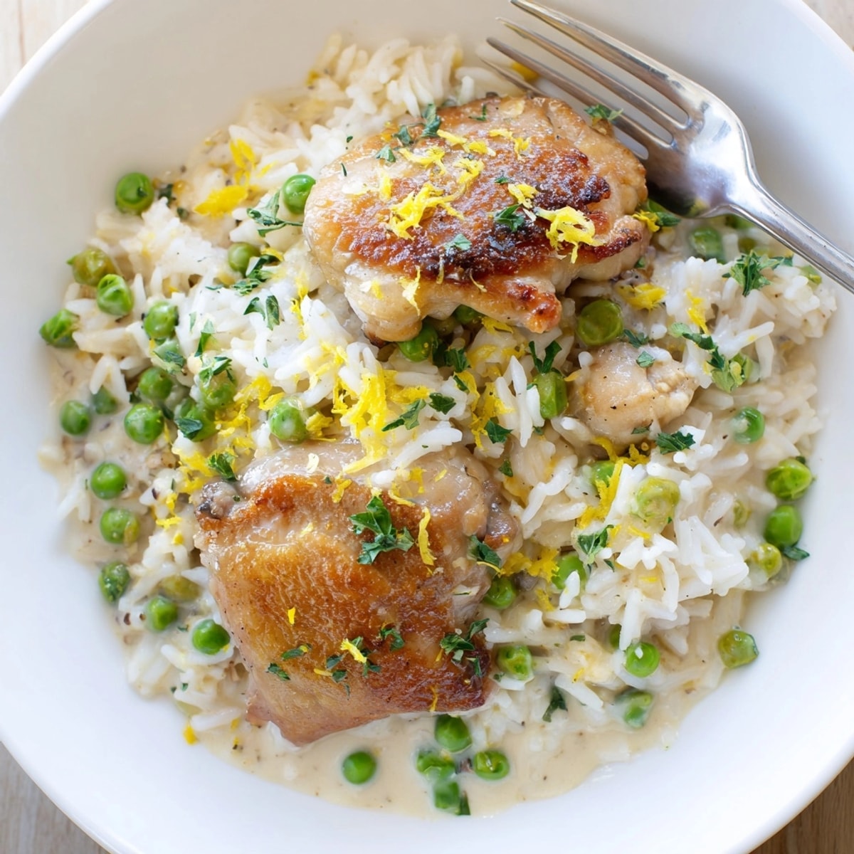 One-Pot Creamy Lemon Chicken and Rice served in a deep skillet, garnished with fresh parsley.