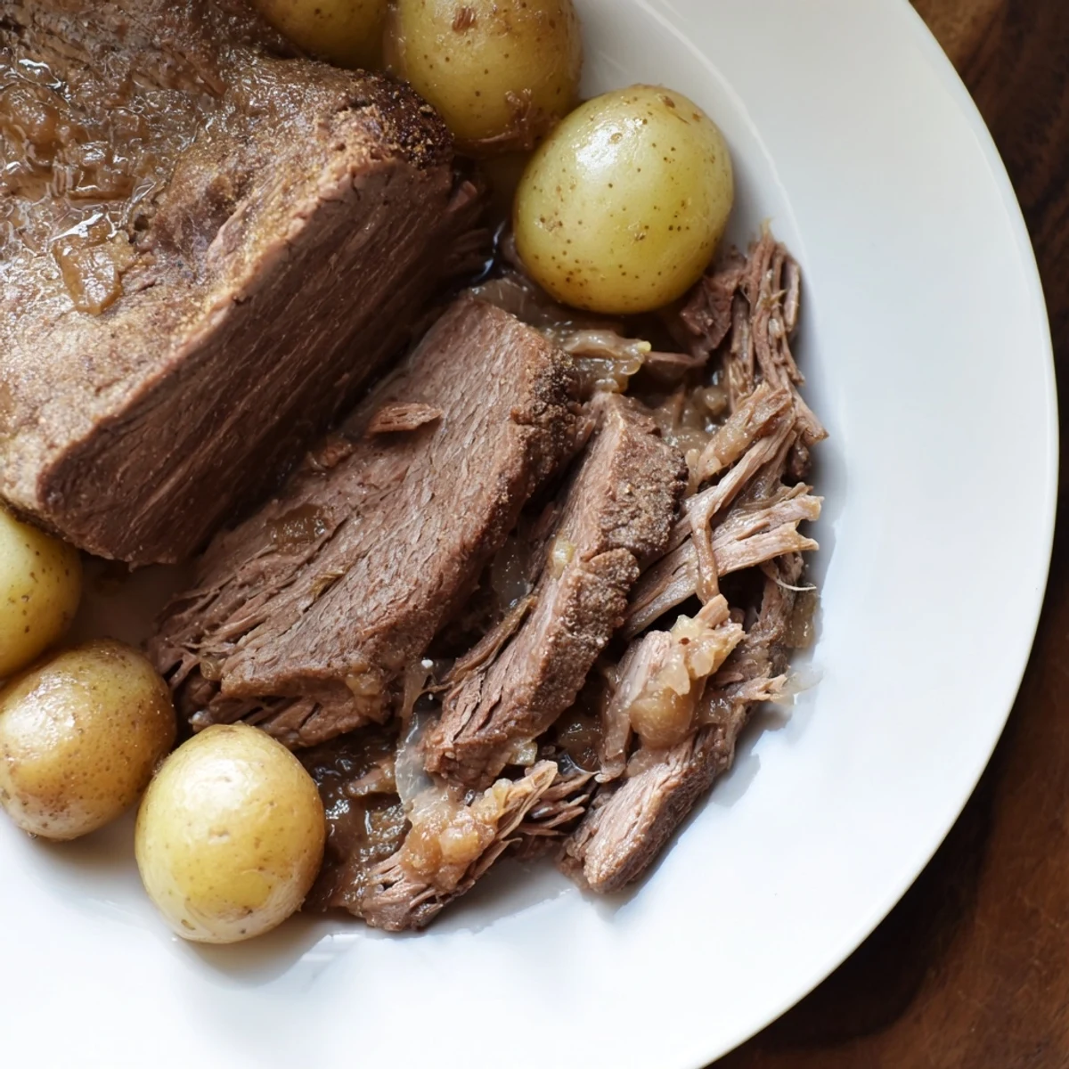 Fork-tender pot roast, perfectly cooked in the slow cooker with potatoes, ready to serve and enjoy.