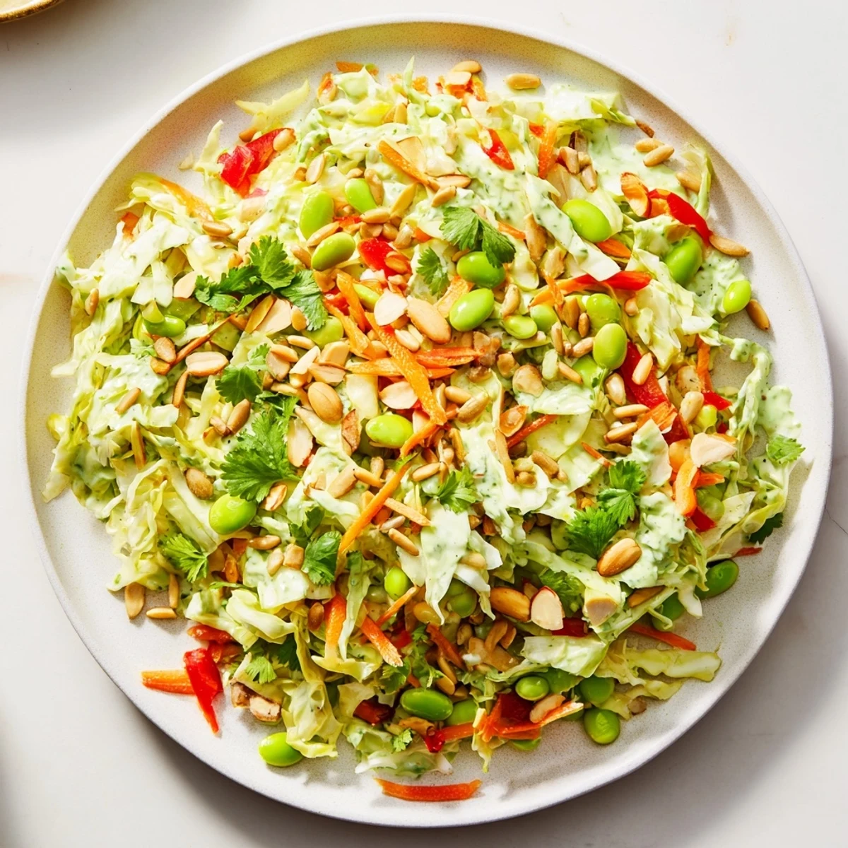 Crisp Crunchy Cabbage and Edamame Salad with vibrant vegetables, topped with crunchy seeds and nuts.