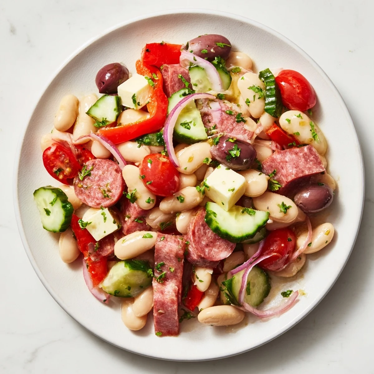 A colorful Italian Antipasto Bean Salad with salami and provolone cheese, ready to serve.