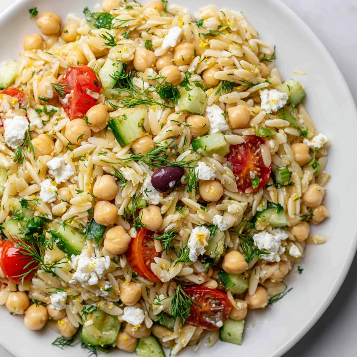 Fresh, chilled Greek Lemon-Orzo Bean Salad with creamy chickpeas, bright tomatoes and herbs.