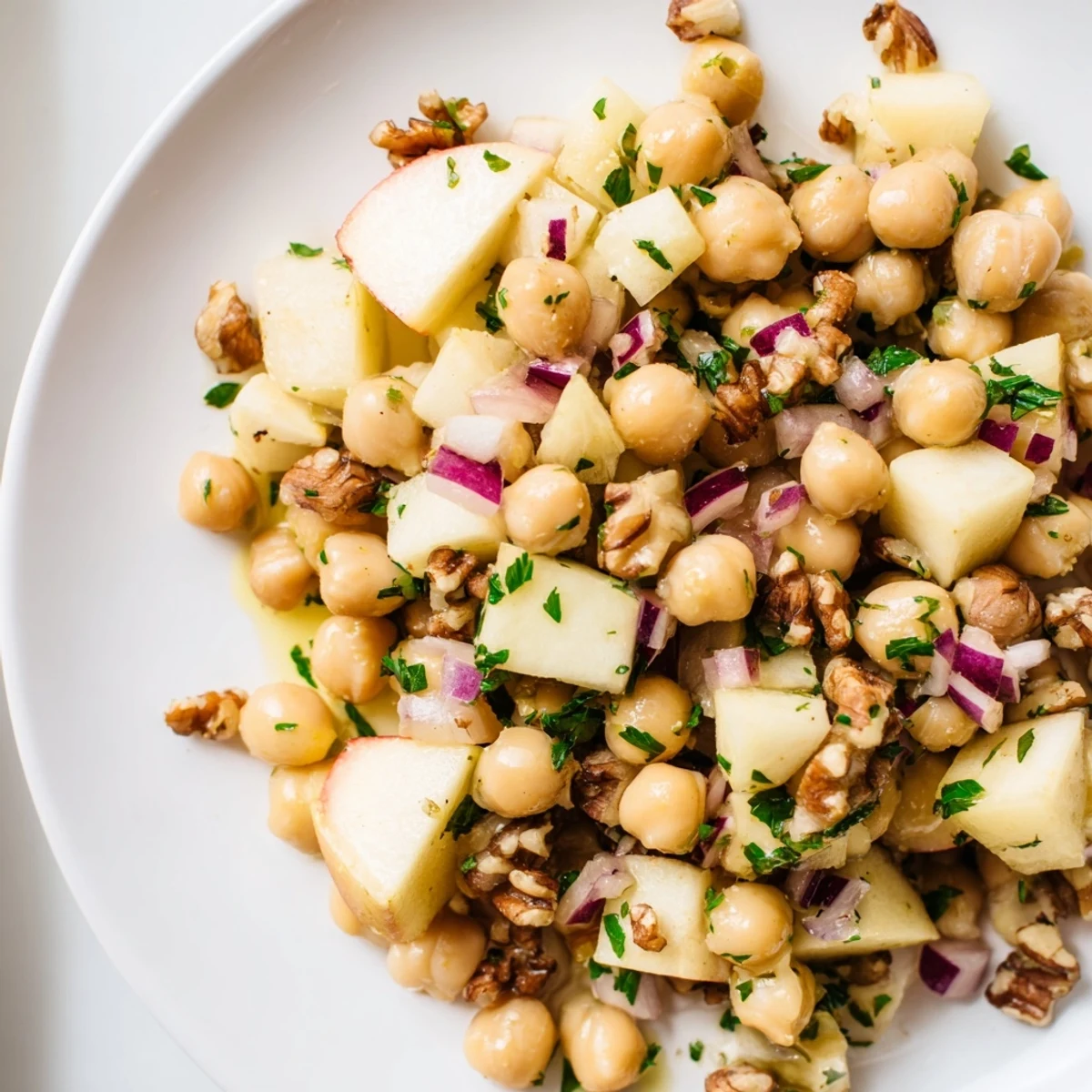 Fall Harvest Apple and Chickpea Salad: A colorful bowl with chopped apples and creamy chickpeas, ready to enjoy.