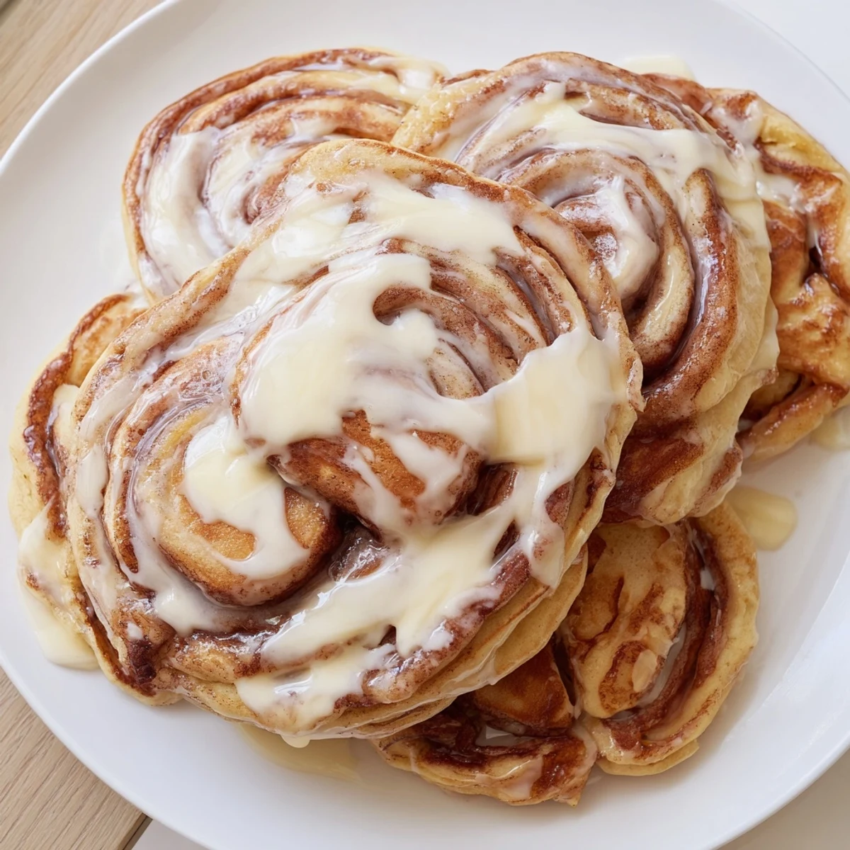 Indulge in warm, homemade Cinnamon Roll Pancakes: sweet, and richly glazed for brunch delight.