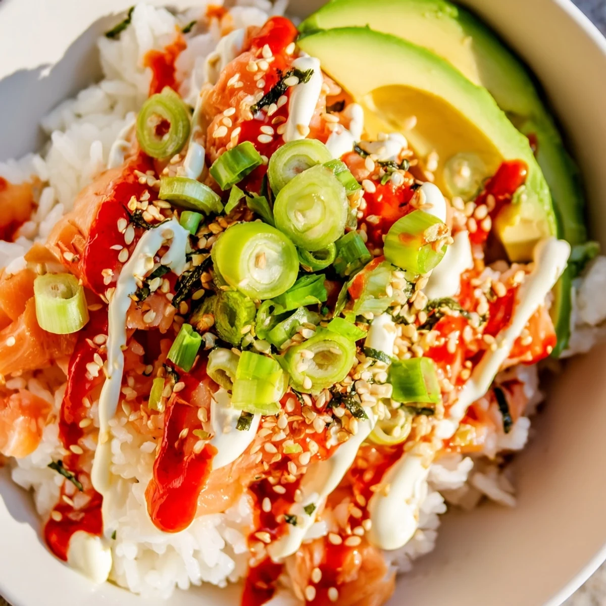 Flaky salmon atop fluffy seasoned rice, a vibrant bowl of Classic Salmon Rice with avocado.