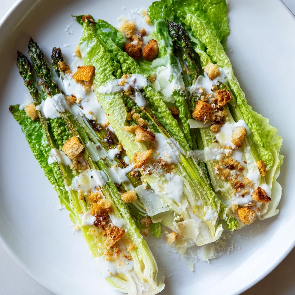 Roasted asparagus spears arranged over crisp romaine lettuce, drizzled with tangy yogurt Caesar dressing.  