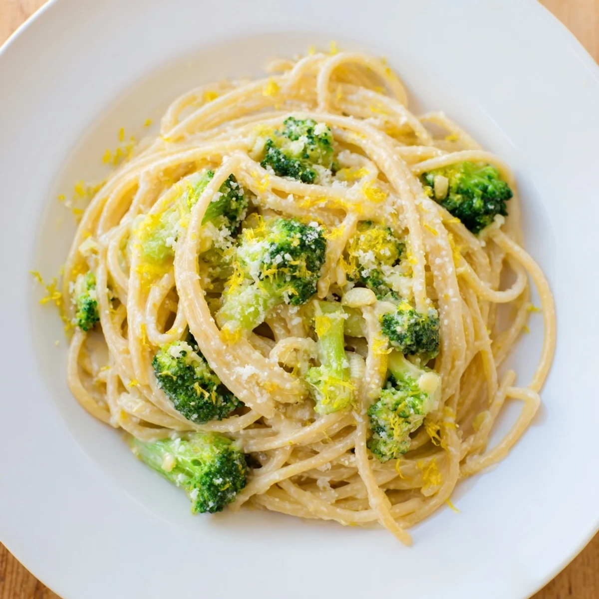 Freshly cooked One-Pot Lemon Broccoli Pasta is plated with bright green broccoli florets and a glossy garlic sauce.