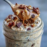 Creamy Protein Cookie Dough Overnight Oats with oats, protein powder, and nuts.