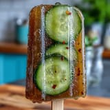 Bright green Pickle Juice Popsicles molded perfectly for a cooling summer snack.