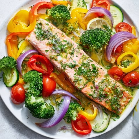 Golden-brown salmon sheet pan bake with colorful roasted veggies, ready to enjoy.