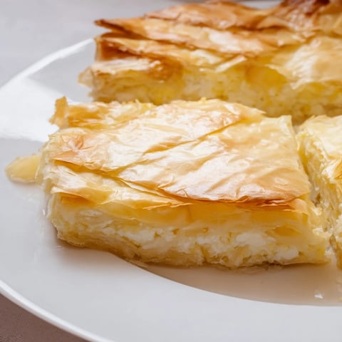 Golden and flaky Bulgarian Banitsa, a savory pastry, filled with creamy feta and baked perfection.