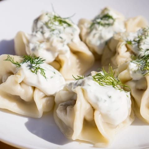 Close-up of golden-brown Russian pelmeni, a satisfying meal ready to be enjoyed.
