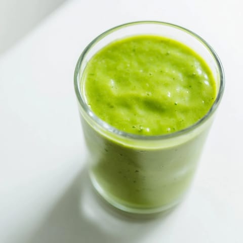 Refreshing Spinach-Hidden Smoothie poured into a mason jar, blending spinach with sweet mango for a healthy breakfast.  