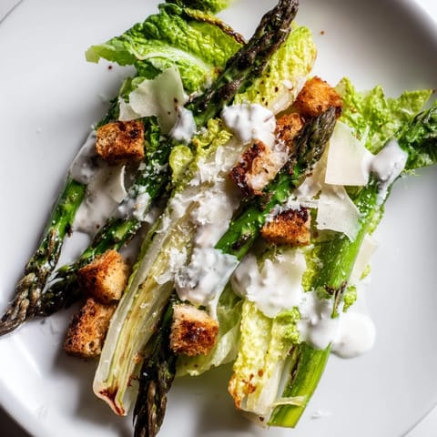 Golden homemade croutons and shaved Parmesan garnish this fresh Roasted Asparagus Caesar Salad.  