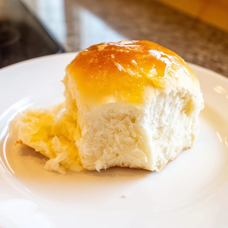 Warm Quick-Rise Dinner Rolls ready to be enjoyed, with a tender crumb and a golden, shiny crust.
