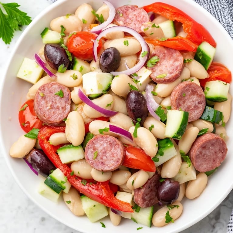 Fresh, zesty Italian Antipasto Bean Salad; featuring tomatoes, beans and savory dressing, for a light meal.