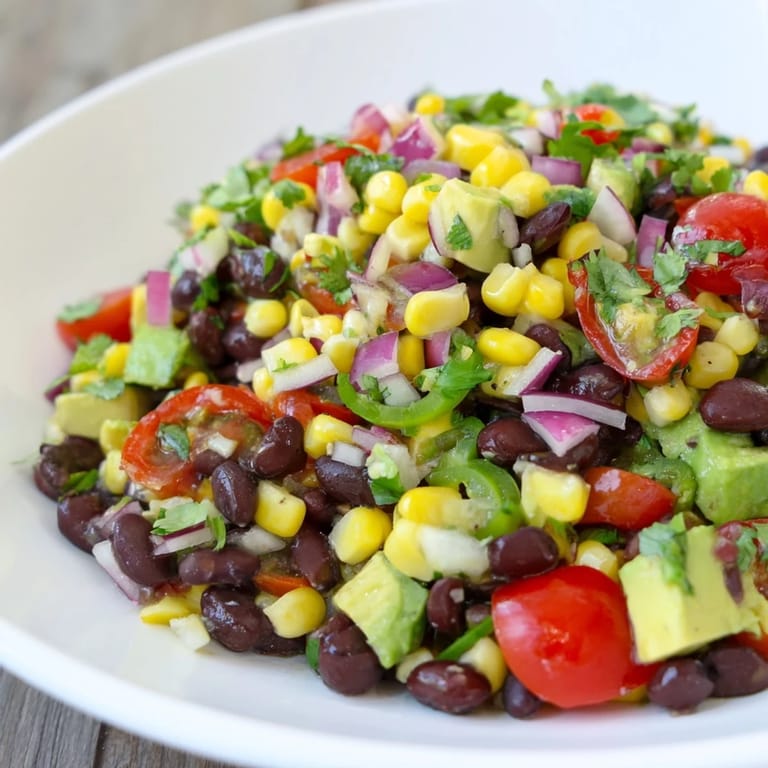 Fresh Southwestern Black Bean and Corn Salad, a vegetarian delight, showcasing a vibrant medley of textures and flavors.