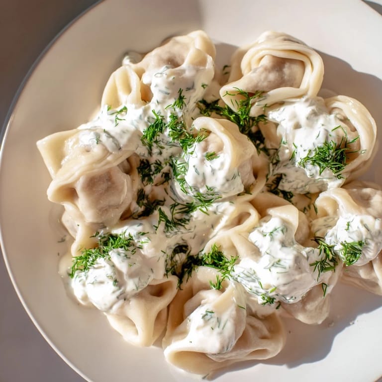Savory Russian pelmeni, showcasing perfectly crimped edges and a flavorful meat filling, ready to eat.