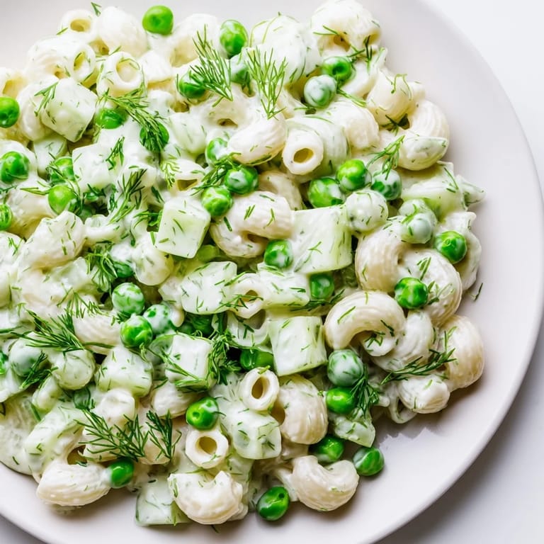 Close-up photo of Creamy Dill Pickle Pasta Salad with fresh dill garnish, showcasing the creamy dressing clinging to every ditalini noodle.